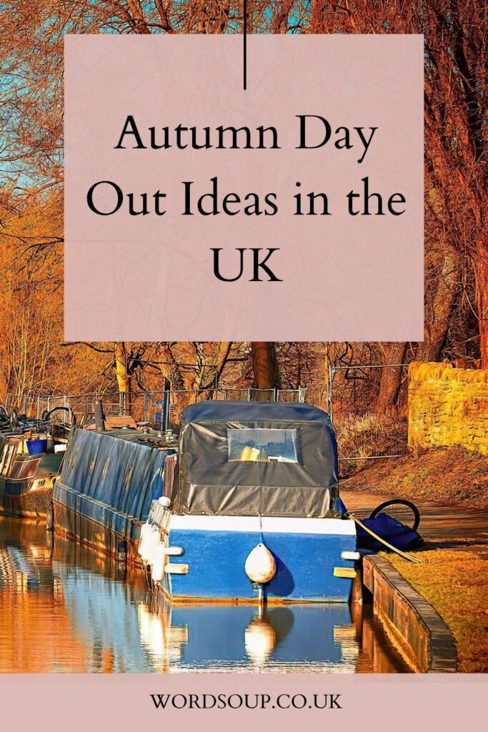 Narrowboats moored on a calm canal lined with autumn trees. Text overlay reads Autumn Day Out Ideas in the UK. Website wordsoup.co.uk at the bottom.
