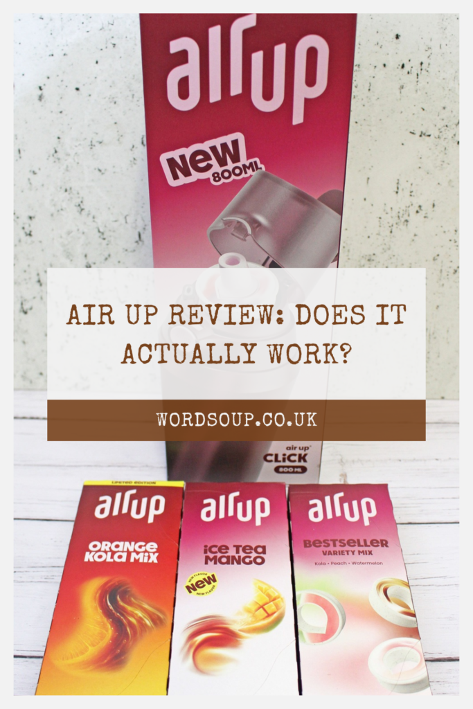 Air Up bottle and three Air Up flavour pod boxes (Orange Kola Mix, Ice Tea Mango, Bestseller Variety Mix) with a review title: Air Up Review: Does It Actually Work? and website wordsoup.co.uk.